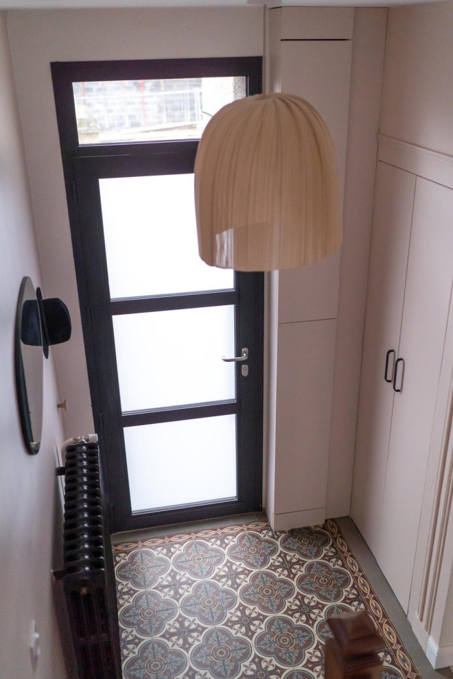This is an example of a small contemporary foyer in Le Havre with pink walls, ceramic floors, a single front door and a metal front door.