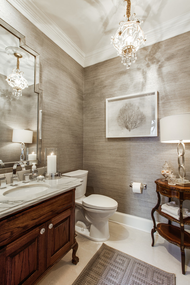 Mid-sized traditional powder room in Atlanta with raised-panel cabinets, dark wood cabinets, a one-piece toilet, grey walls and an undermount sink.
