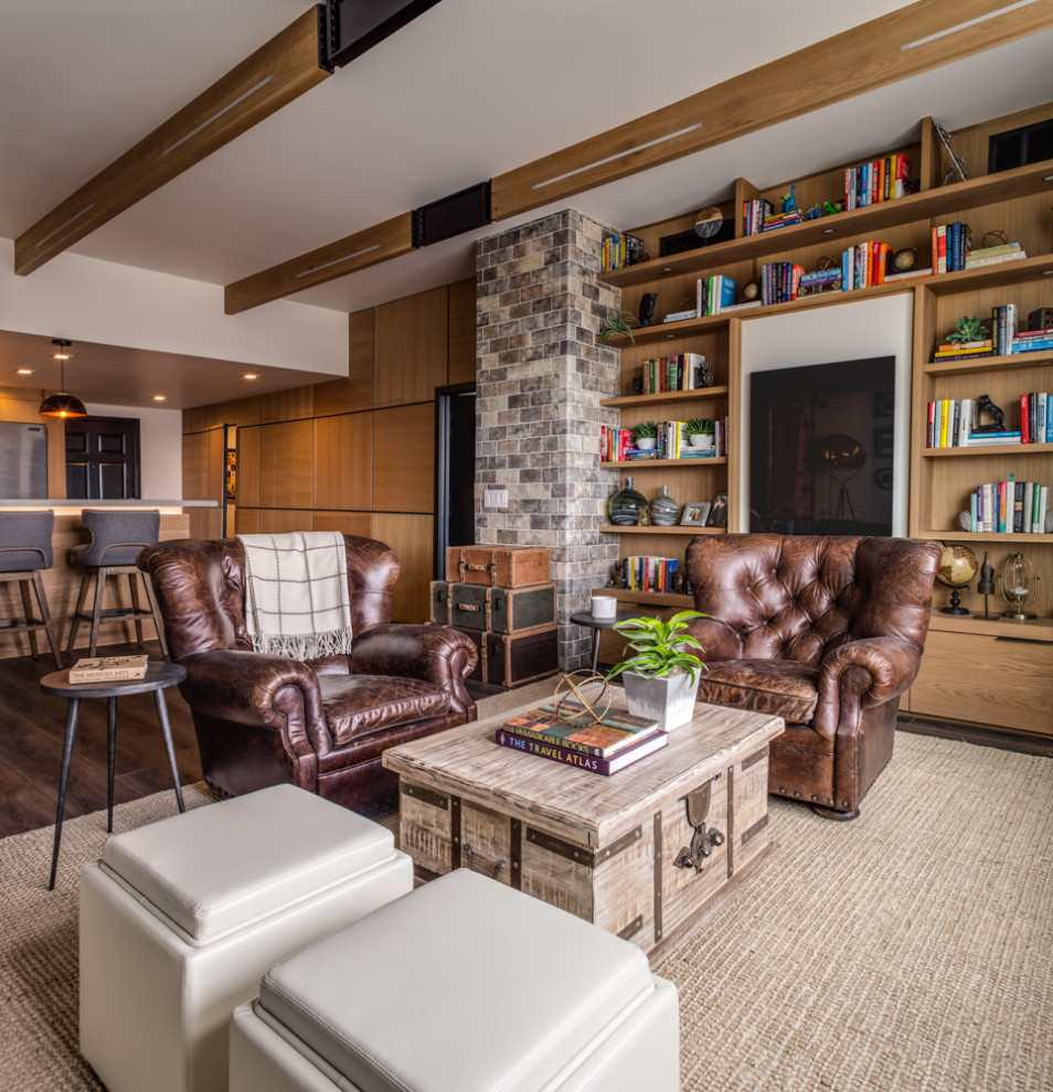 Photo of a mid-sized industrial open concept living room in Las Vegas with a library, white walls, vinyl floors, a hanging fireplace, a wood fireplace surround, no tv and brown floor.
