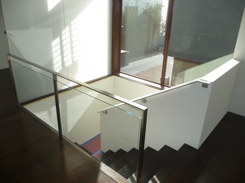 Photo of a contemporary wood u-shaped staircase in Los Angeles with wood risers.