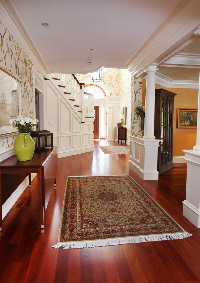 Large traditional hallway in Boston with multi-coloured walls, medium hardwood floors and brown floor.