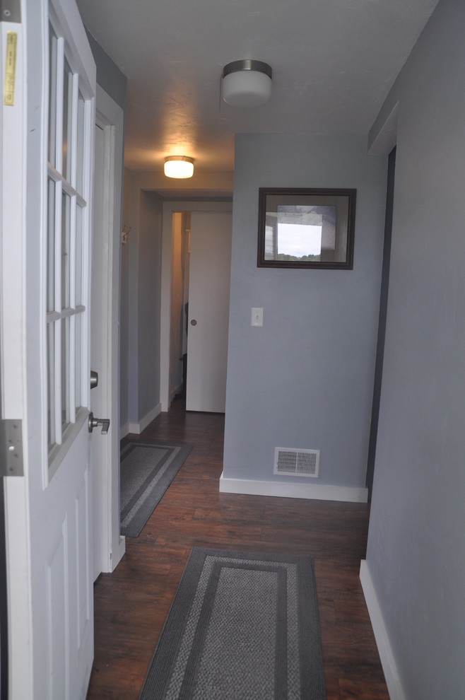 Inspiration for a mid-sized transitional medium tone wood floor and brown floor hallway remodel with gray walls