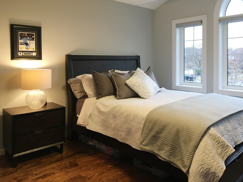 Example of a transitional bedroom design in Toronto