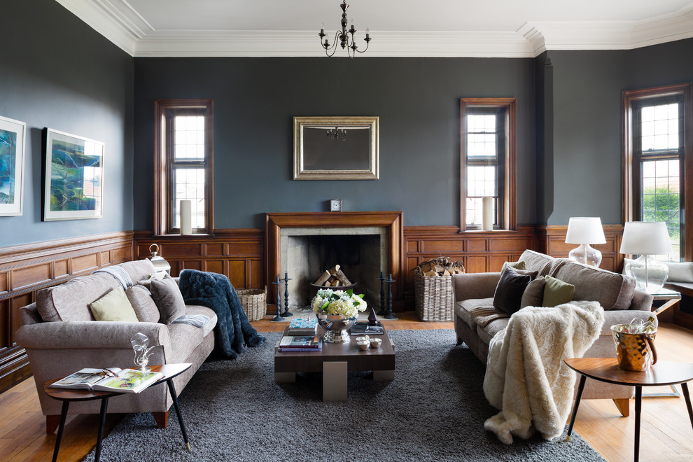 Inspiration for a traditional formal living room in Surrey with grey walls, medium hardwood floors, a standard fireplace and no tv.