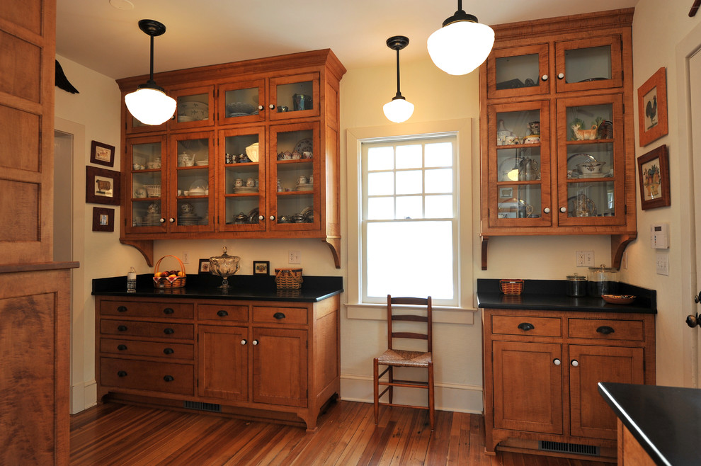 This is an example of a traditional kitchen in New York with beaded inset cabinets and medium wood cabinets.