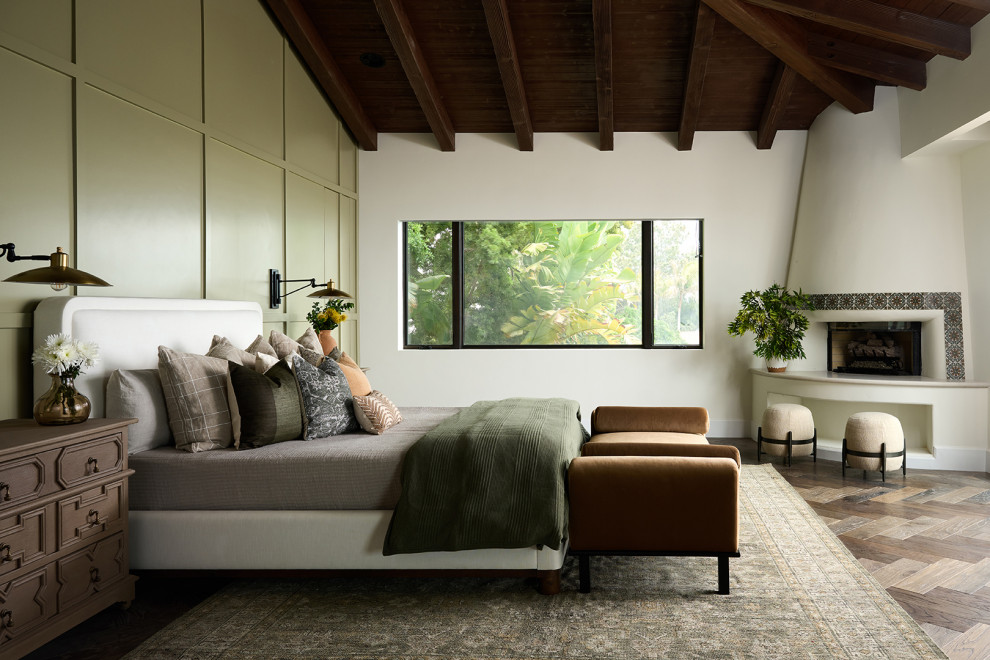 Bedroom - mediterranean dark wood floor, brown floor, exposed beam, vaulted ceiling, wood ceiling and wall paneling bedroom idea in San Diego with white walls, a corner fireplace and a tile fireplace
