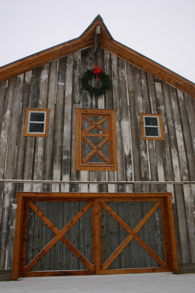 Example of a large mountain style brown two-story wood gable roof design