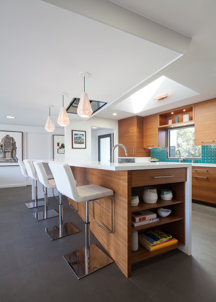 Design ideas for a mid-sized midcentury eat-in kitchen in Los Angeles with with island, quartz benchtops, green splashback, glass tile splashback, stainless steel appliances, flat-panel cabinets, medium wood cabinets and an undermount sink.