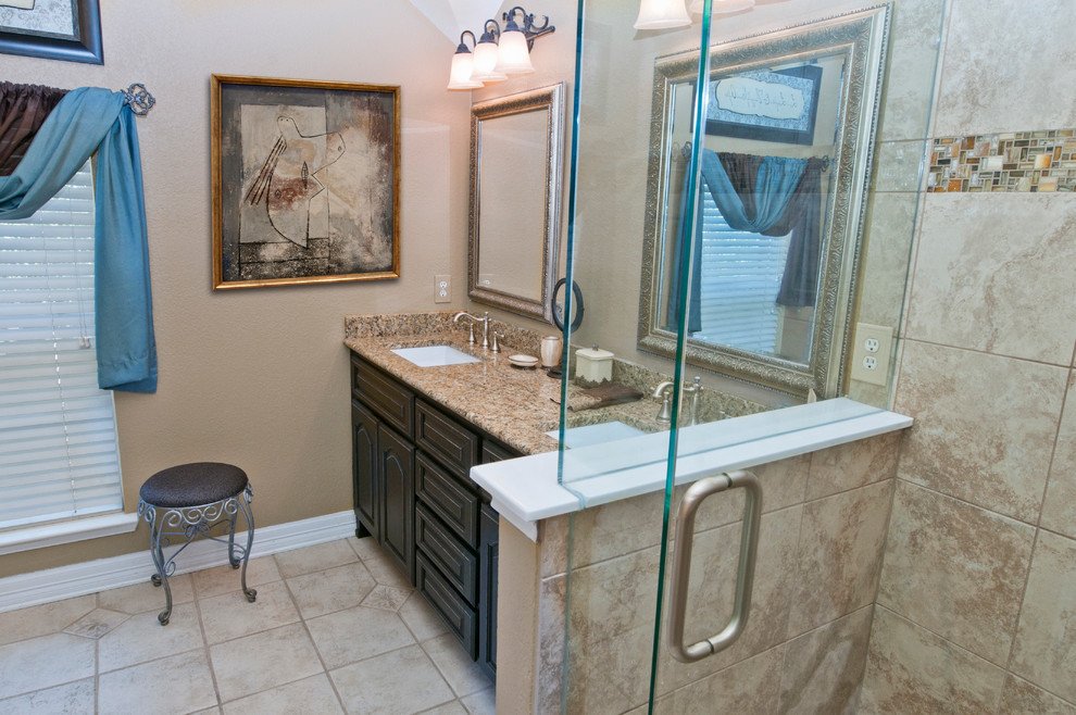 Design ideas for a mid-sized traditional master bathroom in Dallas with an undermount sink, raised-panel cabinets, black cabinets, granite benchtops, an alcove tub, a corner shower, a two-piece toilet, beige tile, ceramic tile, beige walls and ceramic floors.