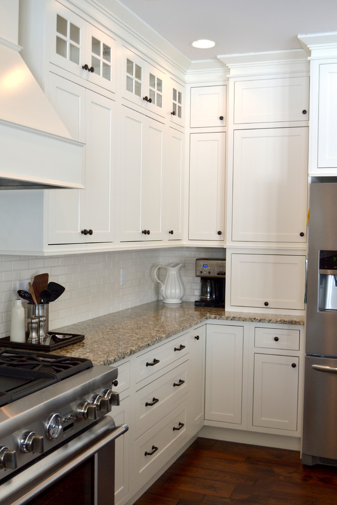Large traditional u-shaped open plan kitchen in Baltimore with shaker cabinets, marble benchtops, white splashback and white appliances.