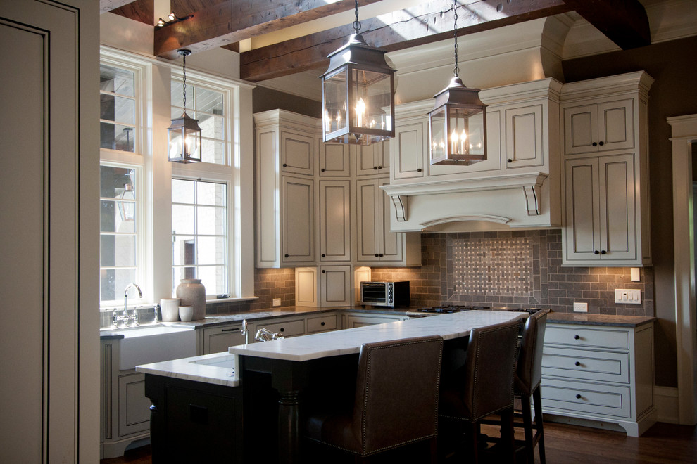 Example of a large transitional u-shaped dark wood floor eat-in kitchen design with a farmhouse sink, beaded inset cabinets, beige cabinets, granite countertops, gray backsplash, stone tile backsplash, paneled appliances, brown walls and an island