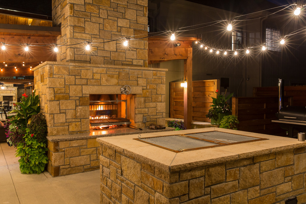 Design ideas for an expansive backyard patio in Kansas City with an outdoor kitchen.