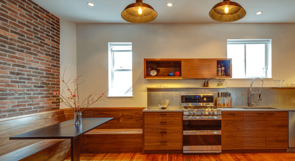 Mid-sized contemporary single-wall eat-in kitchen in San Francisco with an integrated sink, flat-panel cabinets, medium wood cabinets, zinc benchtops, grey splashback, metal splashback, stainless steel appliances, medium hardwood floors, no island and brown floor.