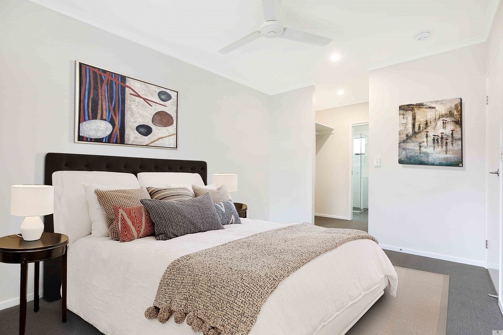 This is an example of a contemporary master bedroom in Brisbane with white walls, carpet and grey floor.