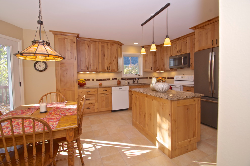 Inspiration for a transitional l-shaped porcelain tile eat-in kitchen remodel with an undermount sink, flat-panel cabinets, light wood cabinets, quartz countertops, beige backsplash, ceramic backsplash, white appliances and an island