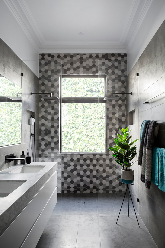 This is an example of a contemporary 3/4 bathroom in Melbourne with flat-panel cabinets, white cabinets, black tile, gray tile, white tile, an undermount sink, a double shower and an open shower.