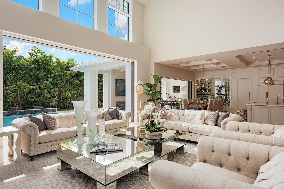 This is an example of a transitional open concept living room in Miami with white walls.