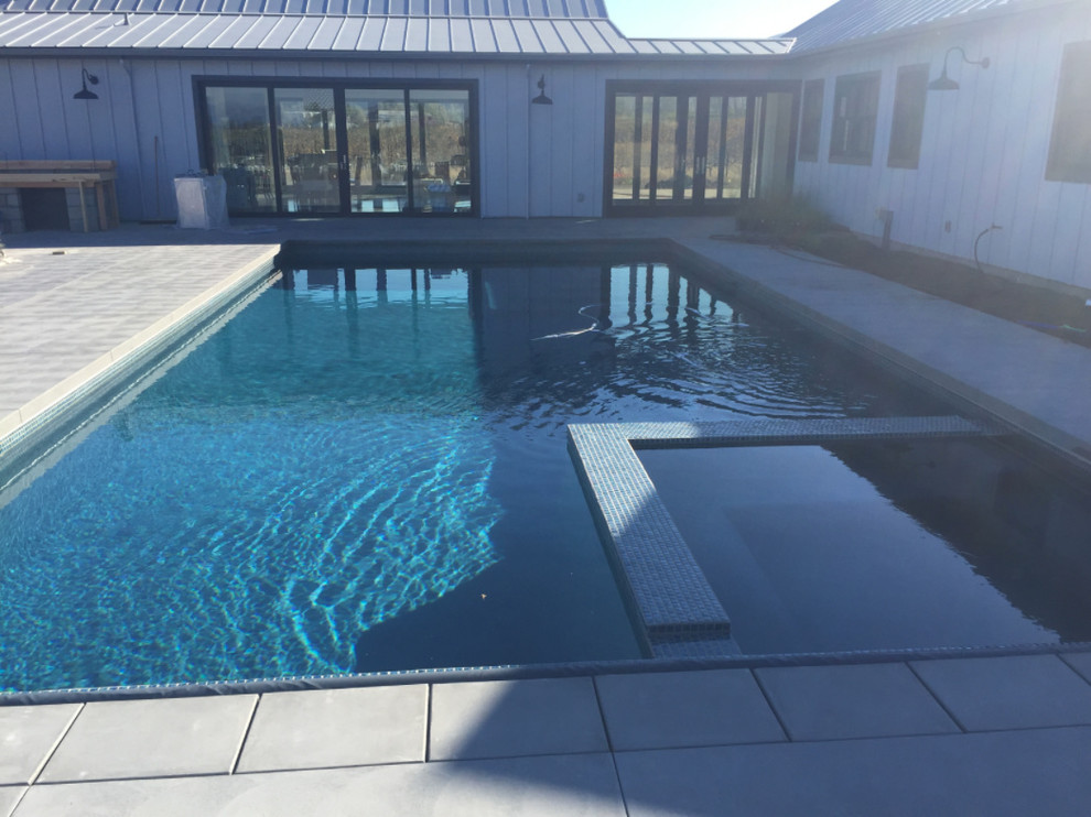 Example of a mid-sized transitional backyard tile and rectangular lap hot tub design in Orange County