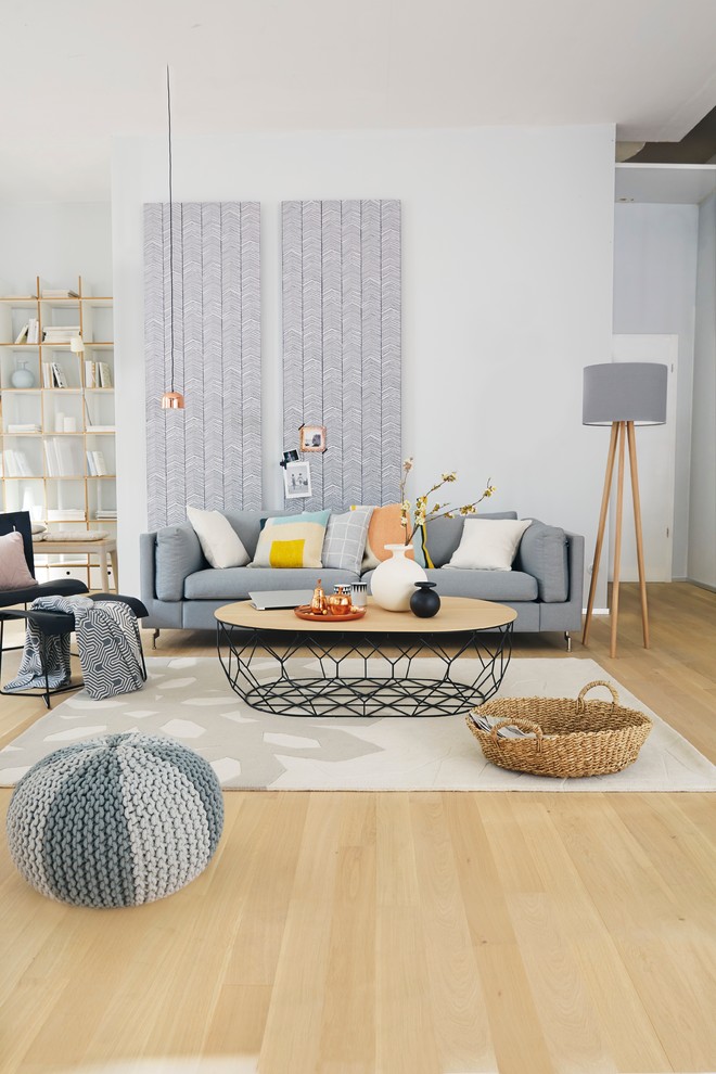 Design ideas for a mid-sized scandinavian living room in Other with white walls and light hardwood floors.