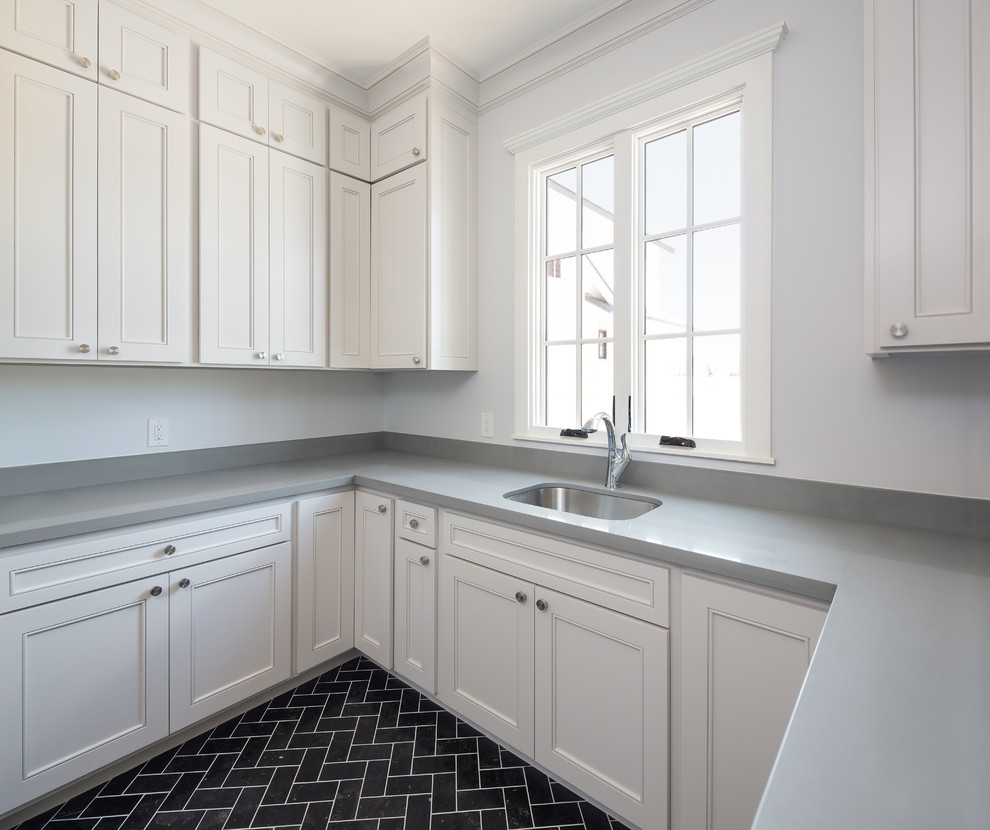 Inspiration for a large transitional u-shaped utility room in Phoenix with an utility sink, shaker cabinets, white cabinets, quartzite benchtops, grey walls, travertine floors and a side-by-side washer and dryer.