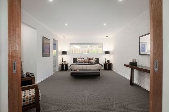 Photo of a mid-sized contemporary bedroom in Melbourne with white walls and carpet.