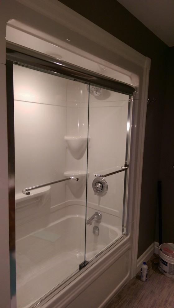 Inspiration for a mid-sized transitional master vinyl floor and multicolored floor alcove bathtub remodel with recessed-panel cabinets, medium tone wood cabinets, a two-piece toilet, gray walls, laminate countertops and yellow countertops