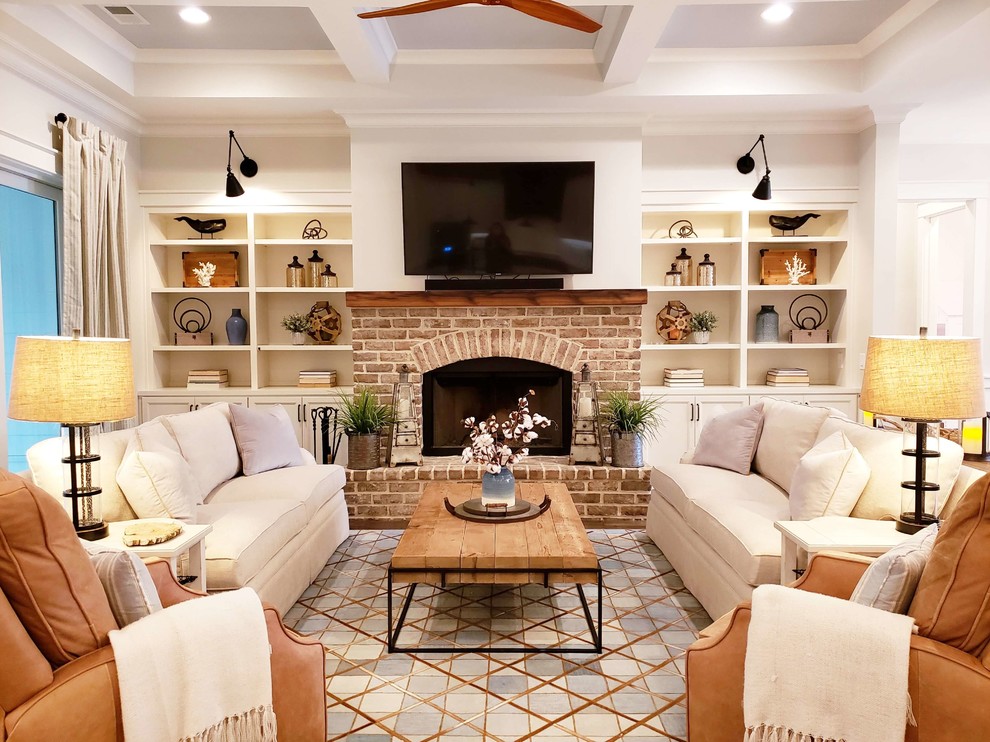 This is an example of a mid-sized country open concept living room in Atlanta with a standard fireplace, a brick fireplace surround, white walls, dark hardwood floors, a wall-mounted tv and brown floor.