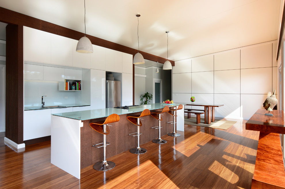 Photo of a contemporary kitchen/dining combo in Wollongong with bamboo floors.