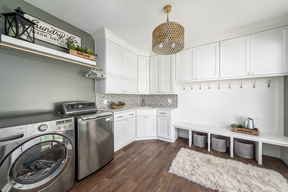 Design ideas for a transitional l-shaped utility room in Columbus with an undermount sink, shaker cabinets, white cabinets, green walls, dark hardwood floors, a side-by-side washer and dryer, brown floor and white benchtop.