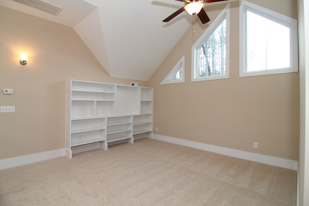 Photo of a large traditional home office in Raleigh with beige walls and carpet.