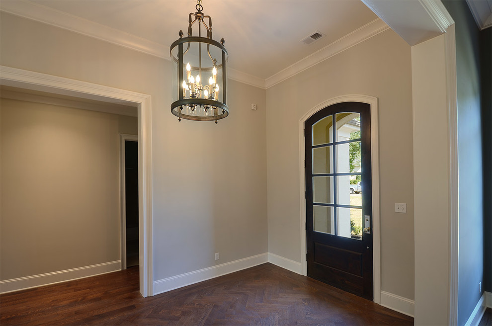 Mid-sized transitional dark wood floor and brown floor foyer photo with gray walls and a glass front door