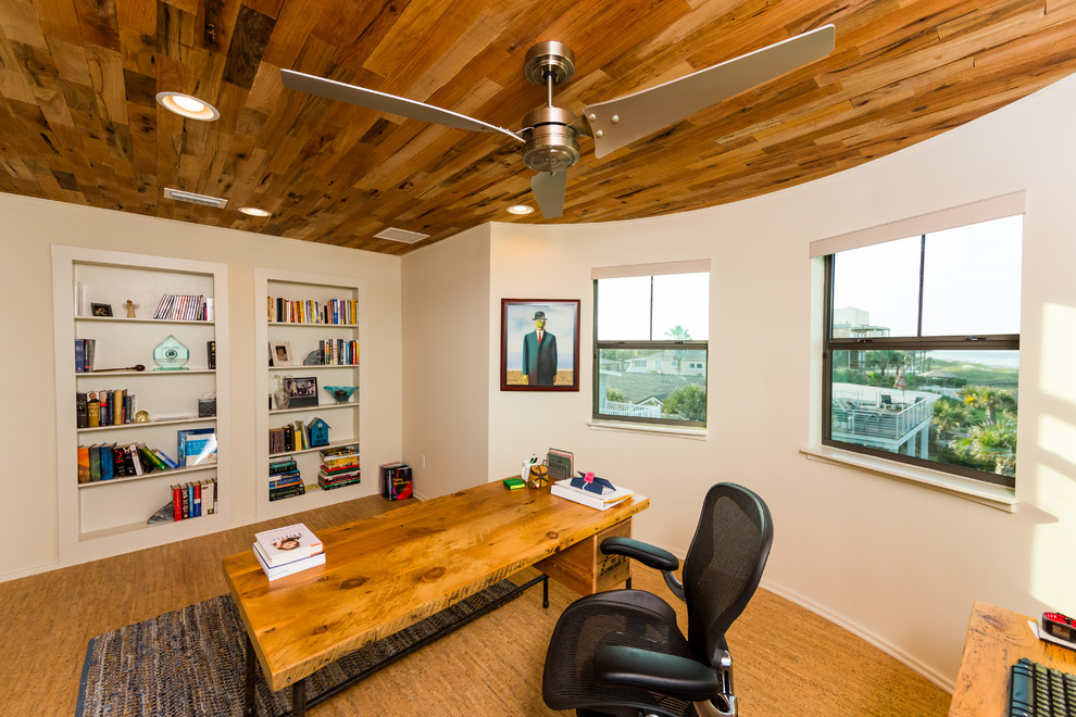 Photo of a mid-sized beach style study room in Jacksonville with white walls, cork floors and a freestanding desk.