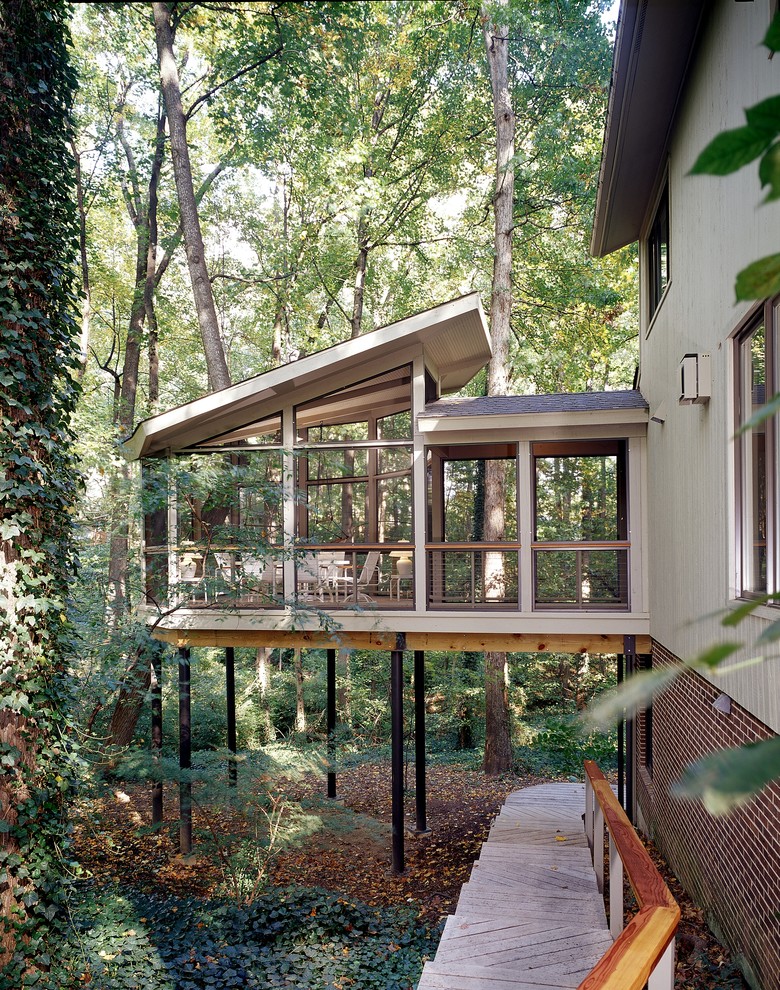 Inspiration for a country screened-in verandah in DC Metro with a roof extension.