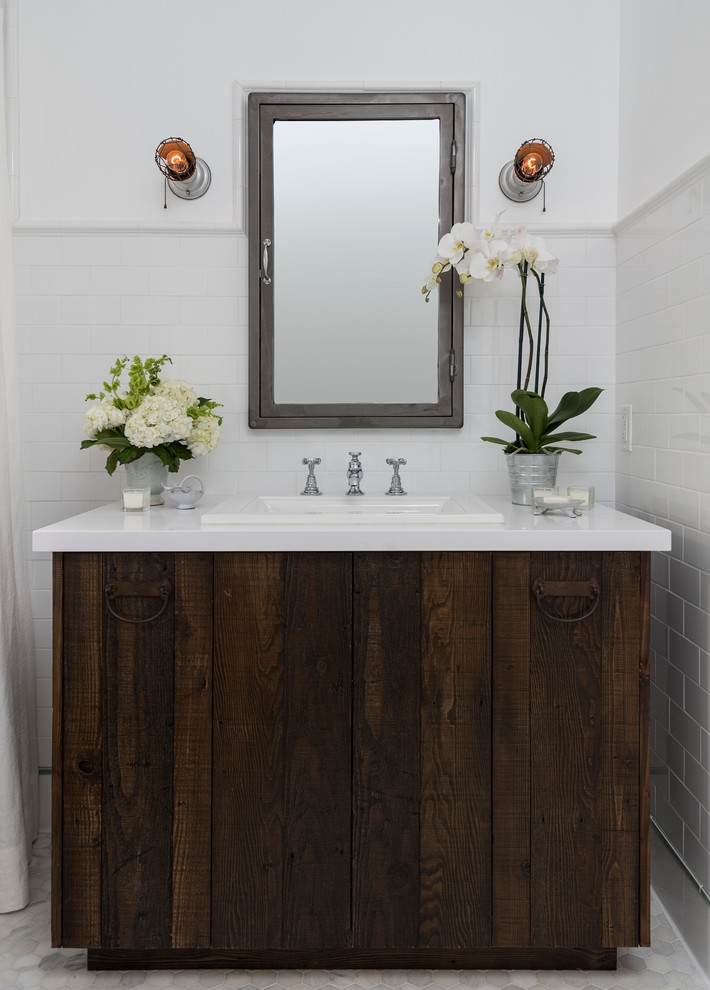 Design ideas for a small country master bathroom in Los Angeles with a drop-in sink, flat-panel cabinets, solid surface benchtops, white tile, subway tile, white walls, marble floors, distressed cabinets and a two-piece toilet.