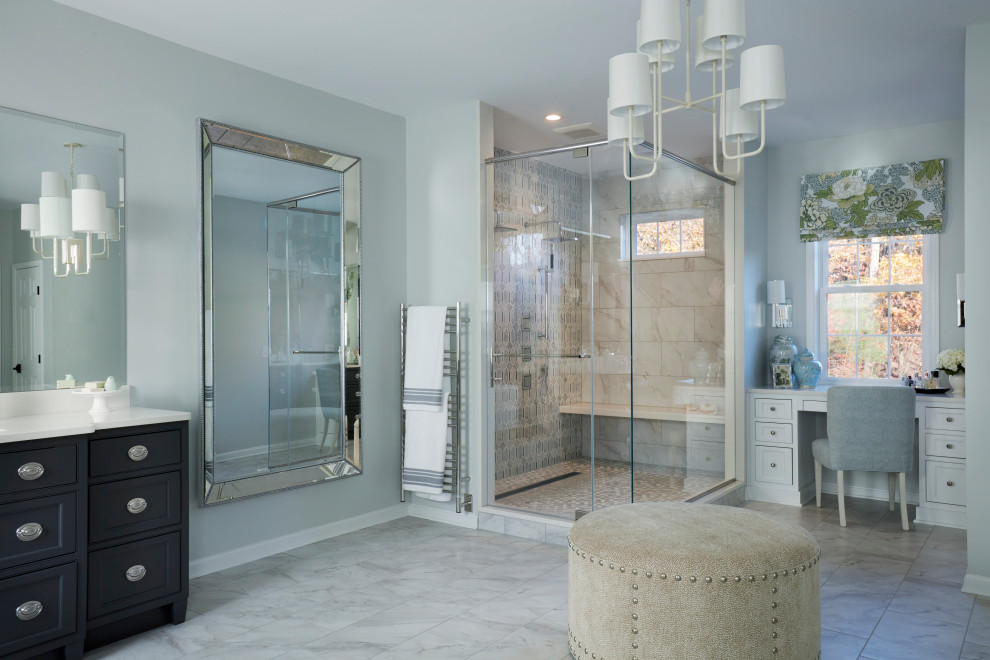 This is an example of a large transitional master bathroom in DC Metro with recessed-panel cabinets, black cabinets, a freestanding tub, a double shower, a two-piece toilet, gray tile, porcelain tile, grey walls, marble floors, an undermount sink, solid surface benchtops, white floor, a hinged shower door, white benchtops, an enclosed toilet, a double vanity and a built-in vanity.