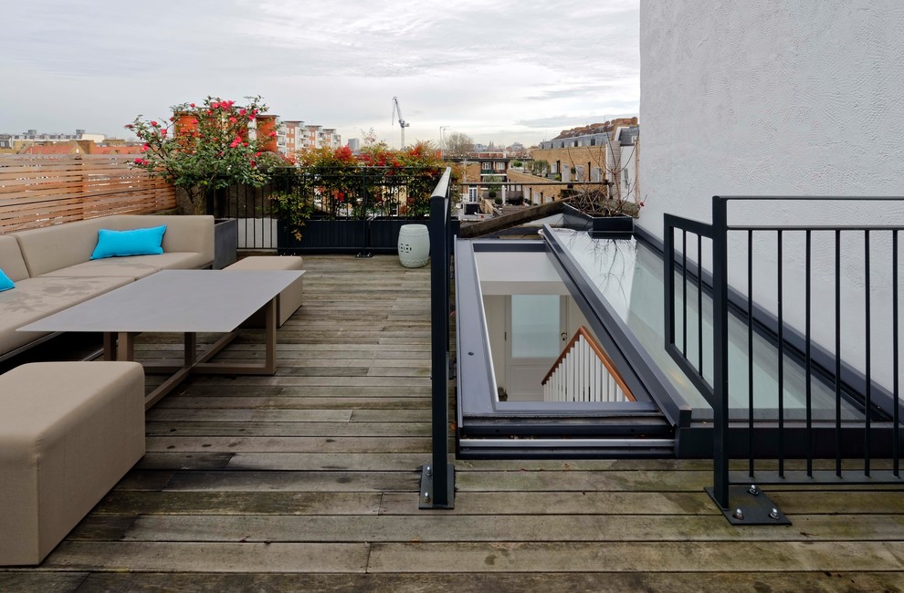 Photo of a mid-sized contemporary rooftop deck in London with a container garden and no cover.