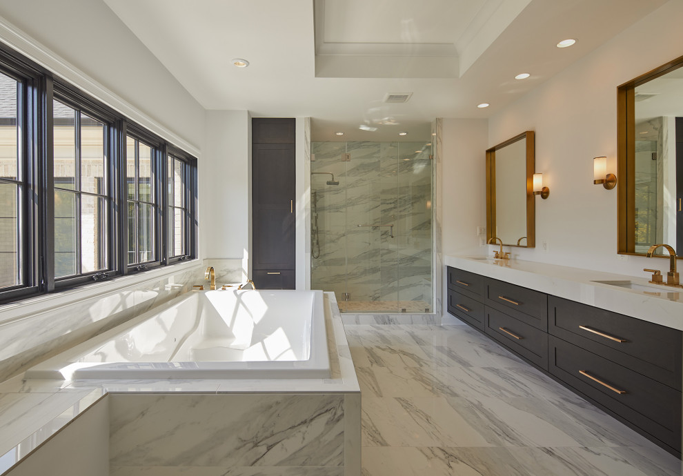 This is an example of a large mediterranean master bathroom in DC Metro with shaker cabinets, grey cabinets, a drop-in tub, an alcove shower, white tile, porcelain tile, white walls, an integrated sink, grey floor, a hinged shower door and white benchtops.