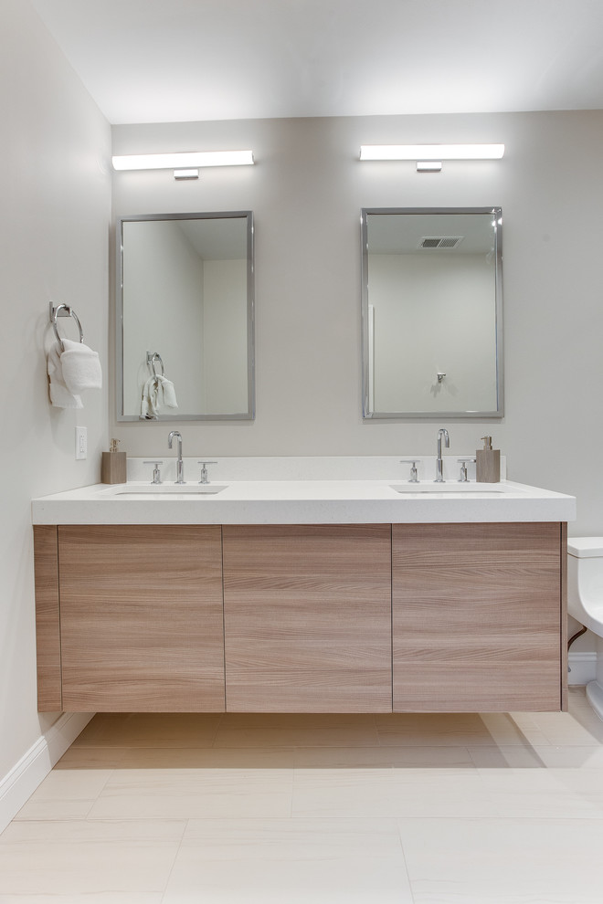 This is an example of a small modern master bathroom in DC Metro with flat-panel cabinets, brown cabinets, a one-piece toilet, gray tile, porcelain tile, grey walls, porcelain floors, an undermount sink, engineered quartz benchtops, grey floor, a hinged shower door and yellow benchtops.