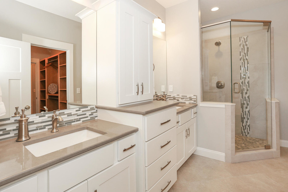 Design ideas for a large arts and crafts master bathroom in Wichita with an undermount sink, shaker cabinets, white cabinets, granite benchtops, a corner shower, gray tile, glass tile, white walls and ceramic floors.