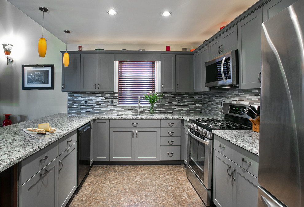 Photo of a mid-sized arts and crafts u-shaped eat-in kitchen in Philadelphia with a double-bowl sink, flat-panel cabinets, grey cabinets, granite benchtops, mosaic tile splashback, stainless steel appliances, porcelain floors, beige floor and multi-coloured benchtop.