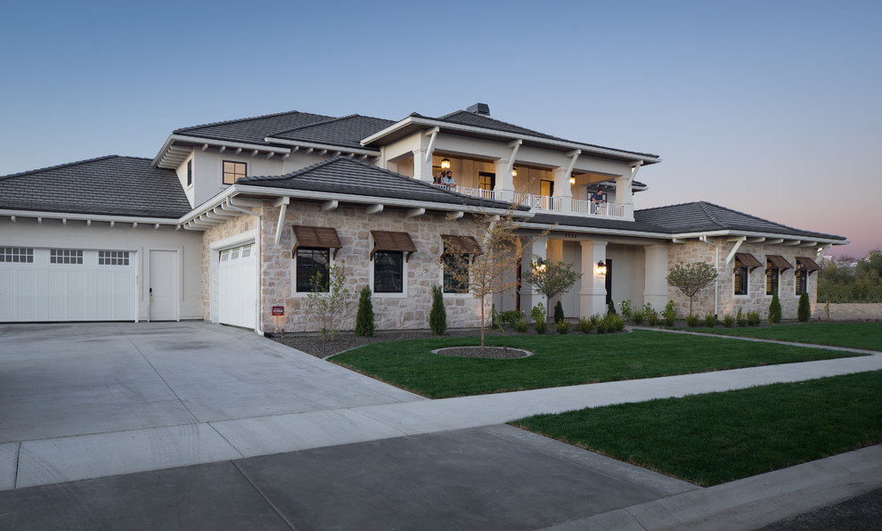 Expansive transitional two-storey beige house exterior in Boise with mixed siding, a hip roof and a tile roof.