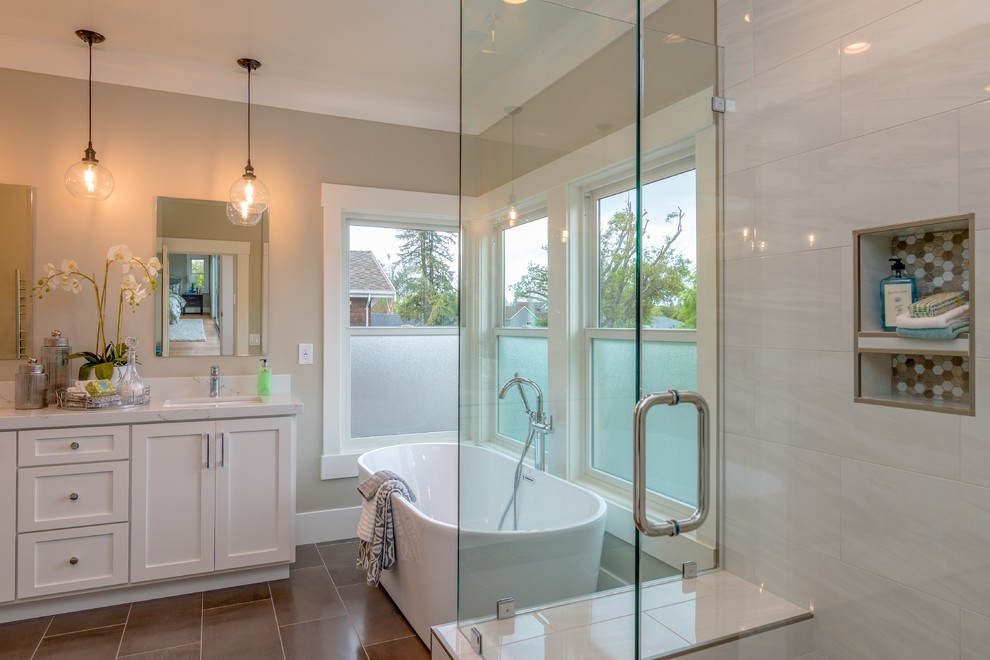Design ideas for a mid-sized contemporary master bathroom in San Francisco with flat-panel cabinets, white cabinets, a freestanding tub, an alcove shower, a one-piece toilet, white tile, ceramic tile, ceramic floors, engineered quartz benchtops, brown floor, a hinged shower door and white benchtops.
