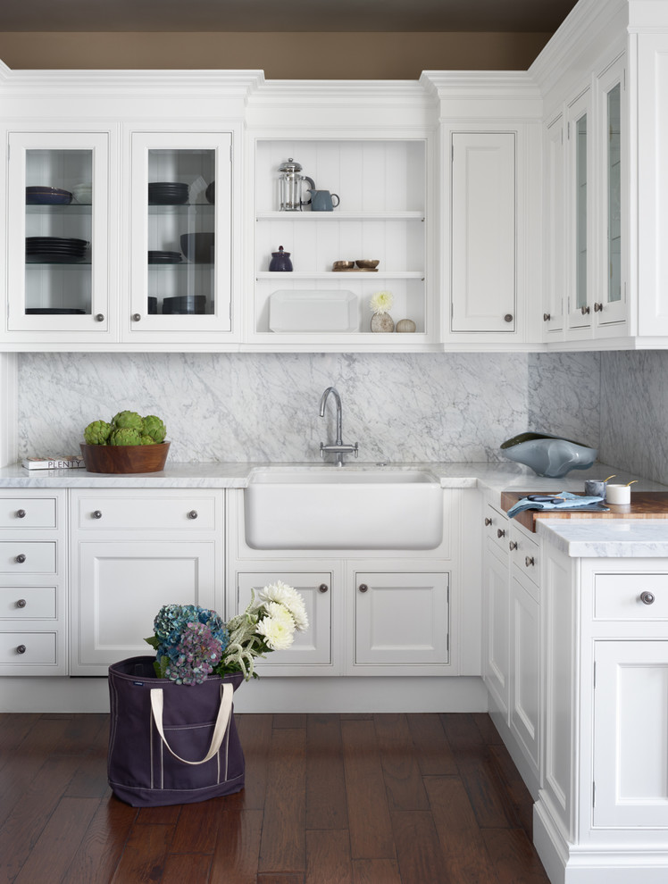 Inspiration for a transitional l-shaped kitchen in San Francisco with a farmhouse sink, beaded inset cabinets, white cabinets, marble benchtops, white splashback, marble splashback, medium hardwood floors and white benchtop.