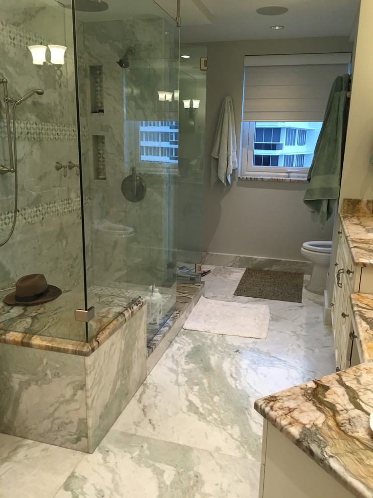 This is an example of a mid-sized traditional master bathroom in Miami with recessed-panel cabinets, white cabinets, an alcove shower, a one-piece toilet, gray tile, white tile, porcelain tile, grey walls, marble floors, an undermount sink, marble benchtops, multi-coloured floor and a hinged shower door.