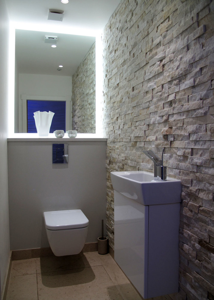 Contemporary powder room in London with limestone.