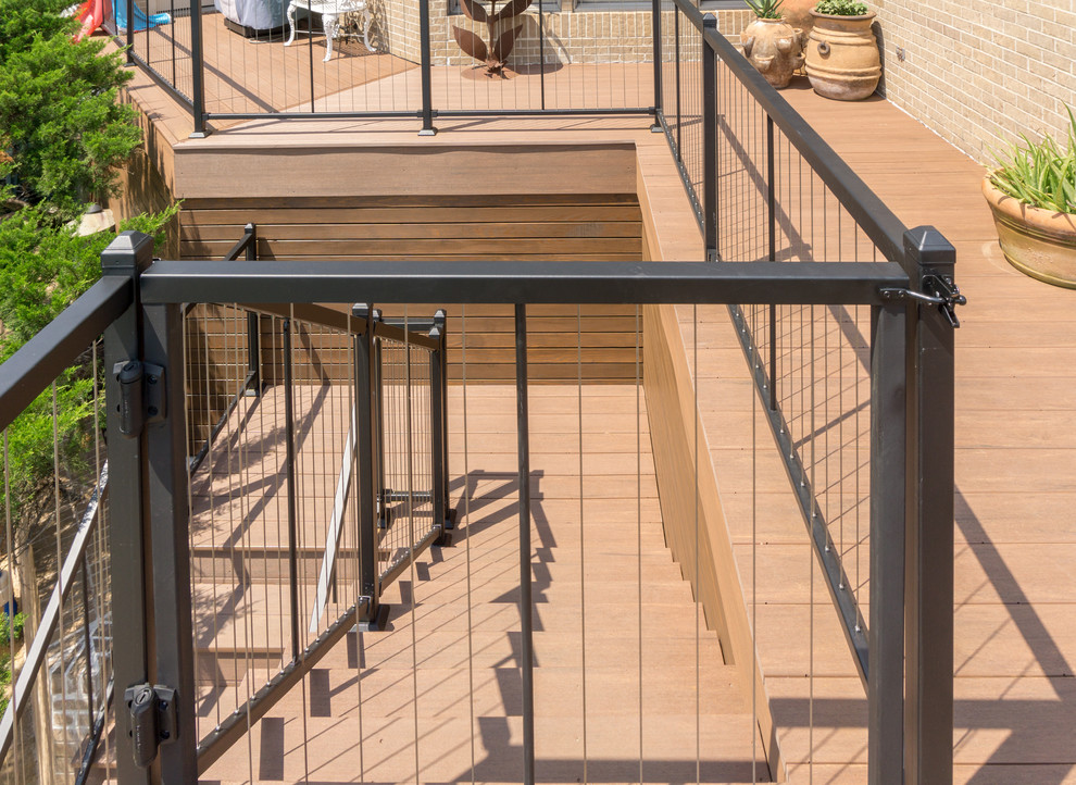 Inspiration for an expansive contemporary backyard deck in Austin with a roof extension.