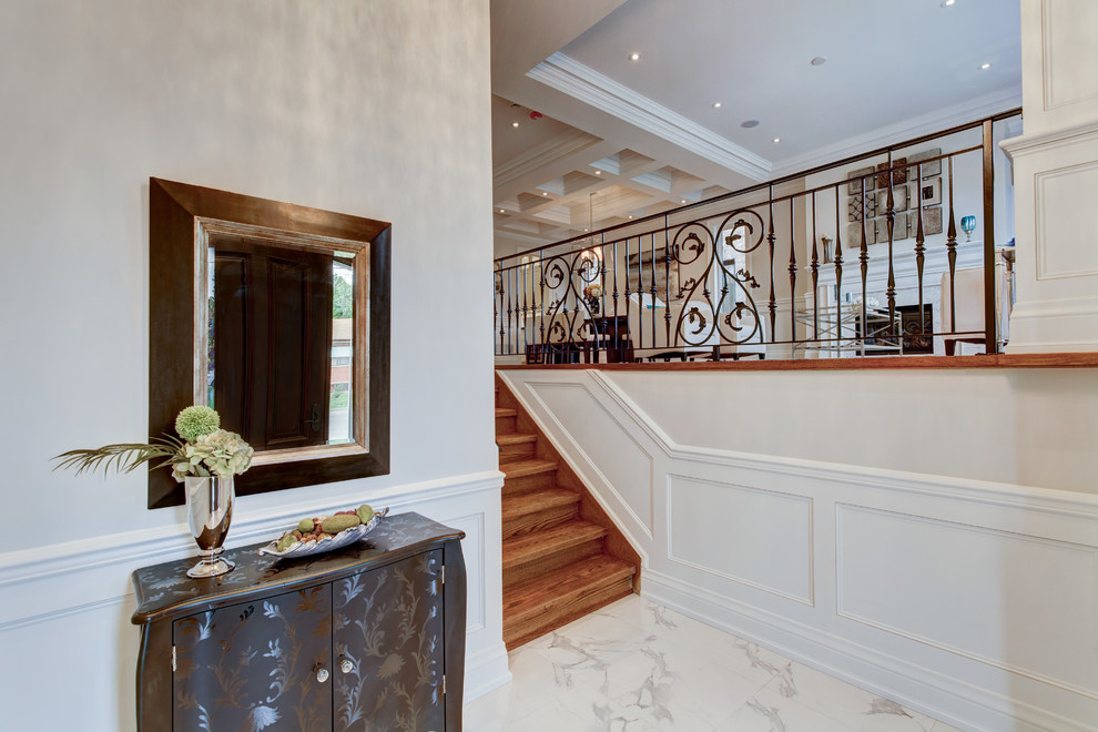 This is an example of a mid-sized transitional foyer in Toronto with grey walls, porcelain floors, a single front door and a dark wood front door.