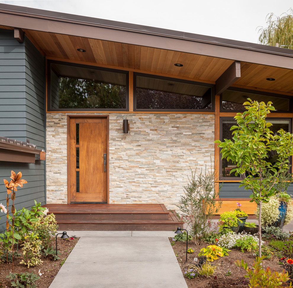 Inspiration for a mid-sized midcentury front door in Seattle with a single front door and a medium wood front door.