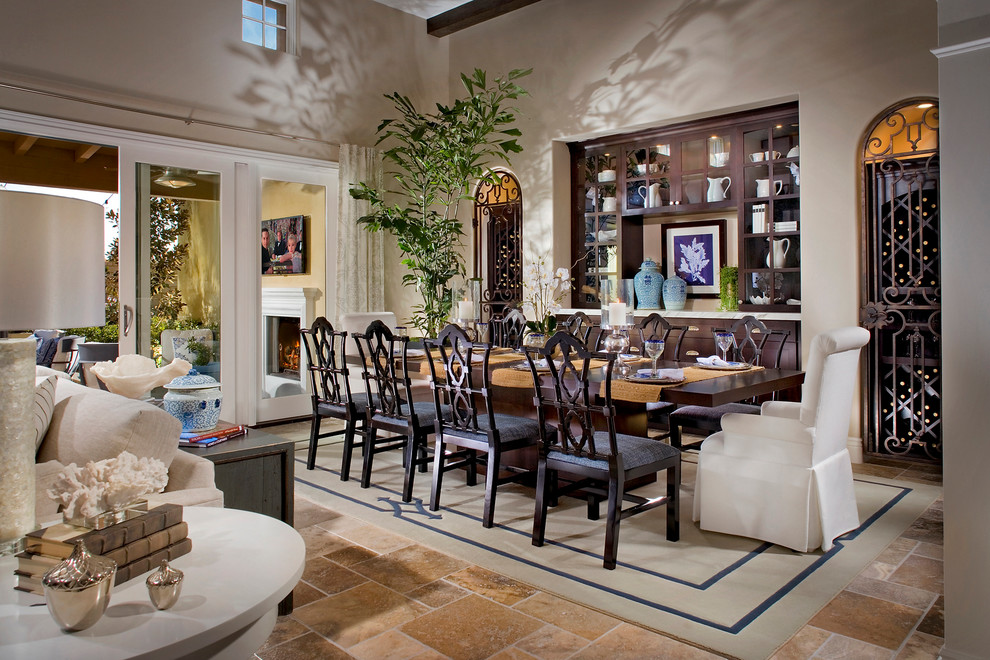 Expansive mediterranean open plan dining in San Diego with beige walls and travertine floors.
