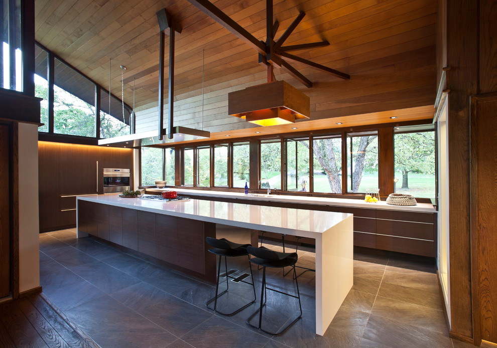 Inspiration for a large midcentury galley eat-in kitchen in Cincinnati with a single-bowl sink, flat-panel cabinets, medium wood cabinets, quartz benchtops, stainless steel appliances, porcelain floors and with island.